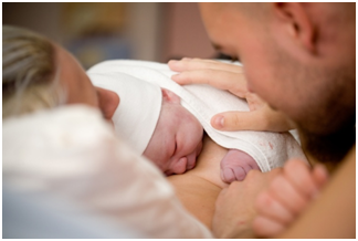 Mother and Father holding a new born